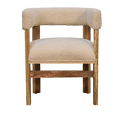 A chair with a cream boucle upholstery made of cotton and natural yarn and a frame and legs made of mango wood