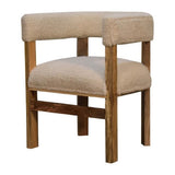 A wooden chair with a cream-coloured boucle fabric that has loops of different sizes
