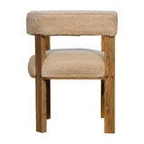 A cream-coloured chair with a curly and textured upholstery and a solid wood frame with an oak-ish finish