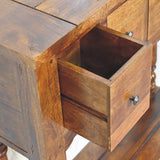 Rustic-inspired narrow console table with a chestnut finish, hand-turned legs, four drawers, and a lower storage shelf