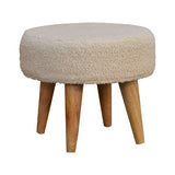 Side view of the footstool highlighting the solid mango wood legs with an oak-ish finish