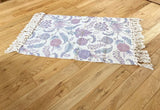 Close-up of a small Paisley Rug with a beautiful blue and pink print and tassels